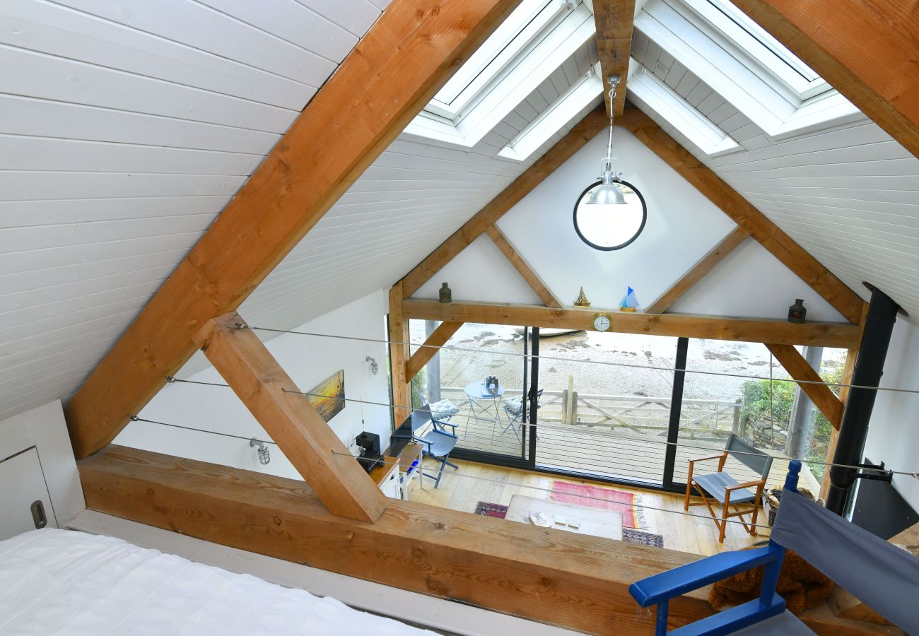 Snug mezzanine double bed in a boutique boathouse – a truly unique place to stay in Dittisham.